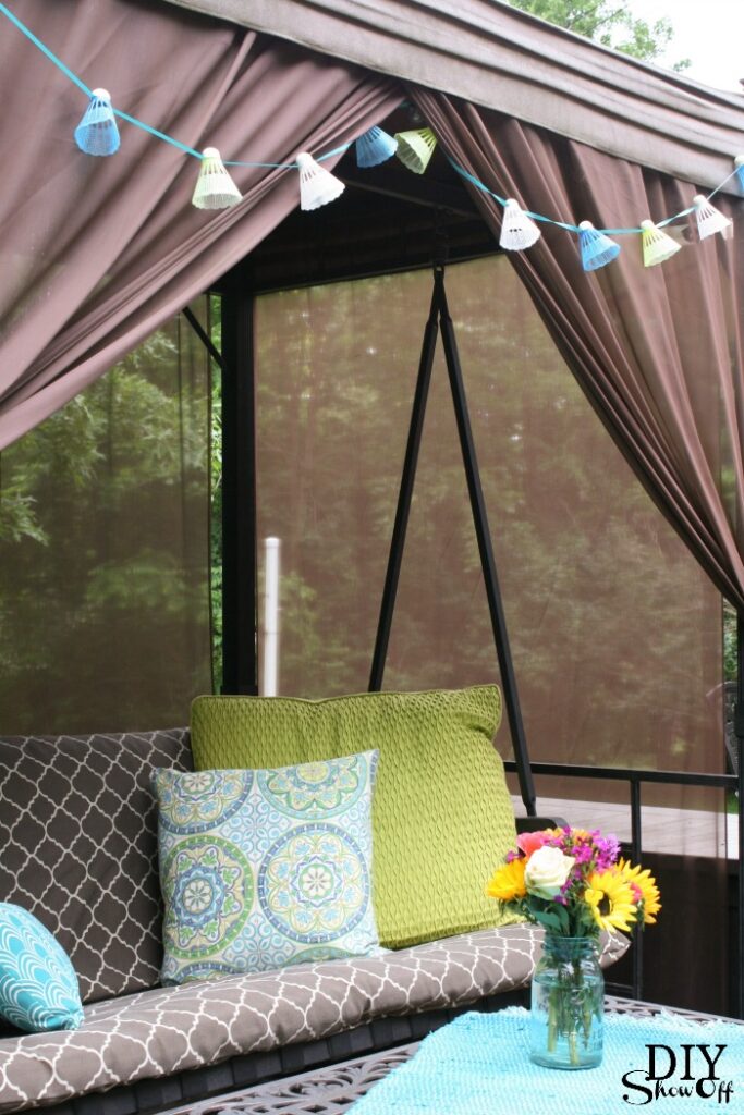 DIY badminton birdie garland hanging on outdoor canopy