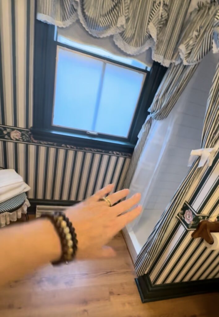 striped wallpapered bathroom with window