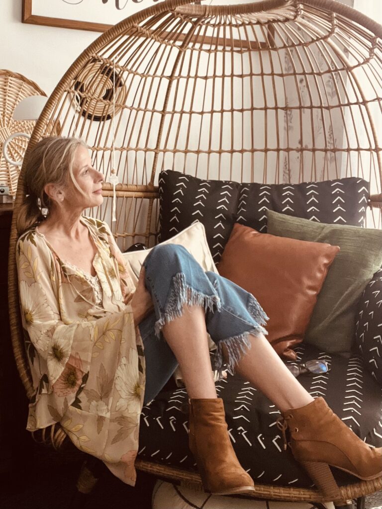 Roeshel sitting in a rattan chair reflecting on a new season of DIYShowOff home blog