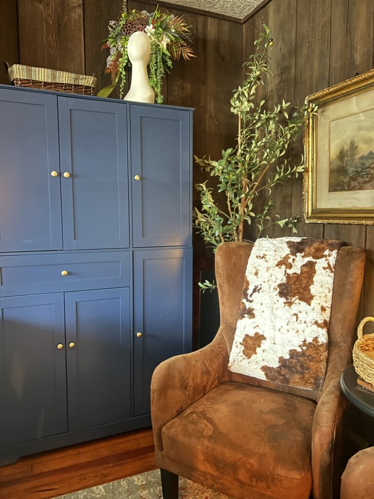 navy-pantry-cabinet, brown wingback chair