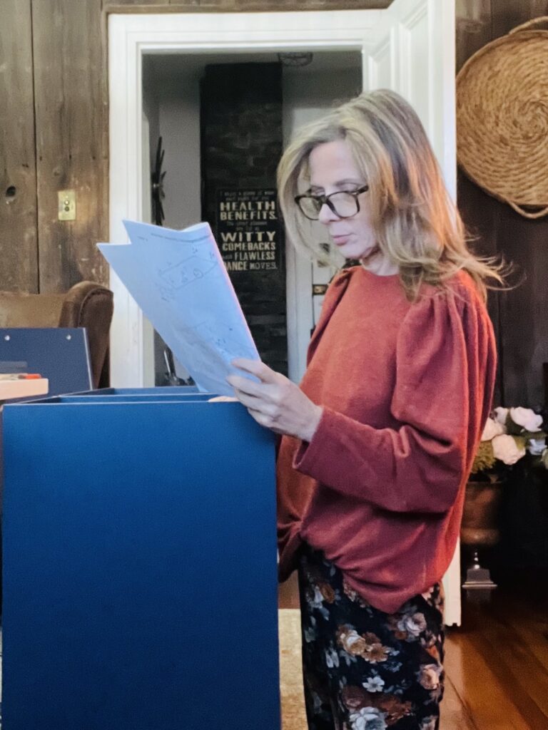 woman assembling furniture reading directions